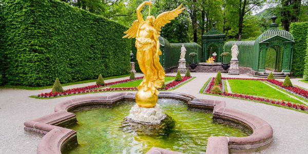 Sculpture of gold angel in the park of Linderhof Palace, Bavaria, Germany.
