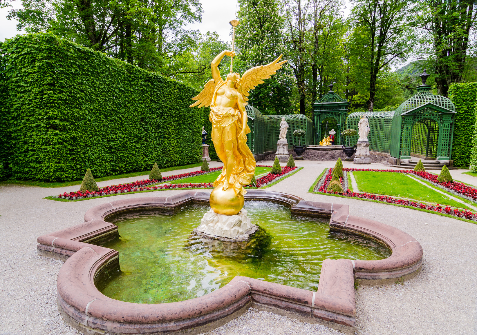 Sculpture of gold angel in the park of Linderhof Palace, Bavaria, Germany.